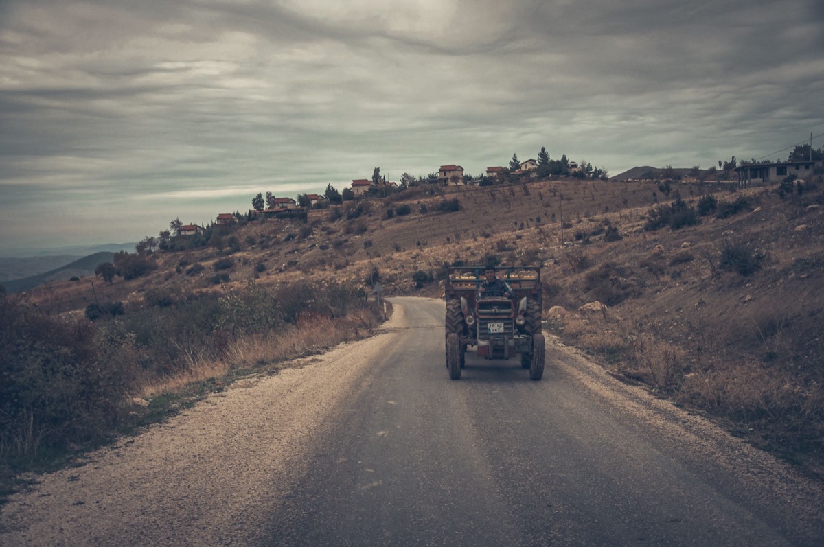 rural russian village with tractor and field workers
